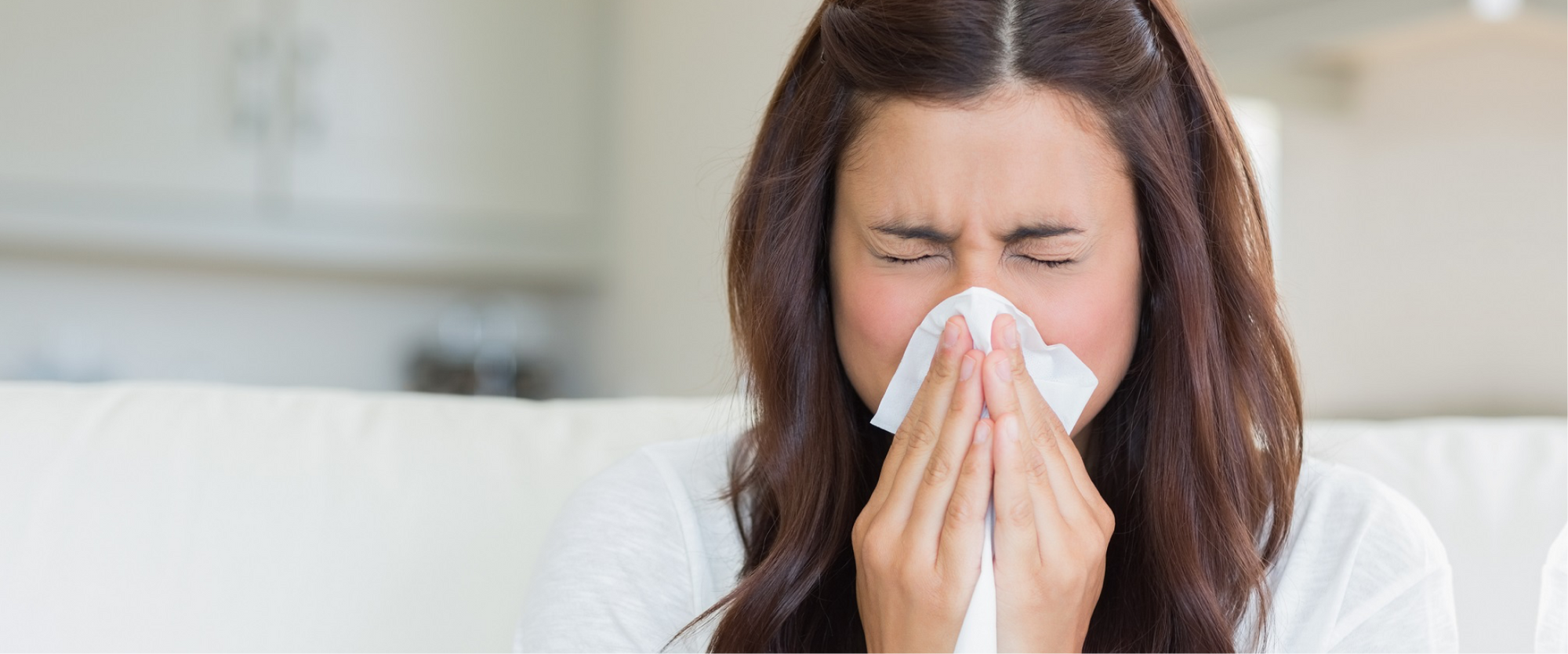 A woman blowing her nose